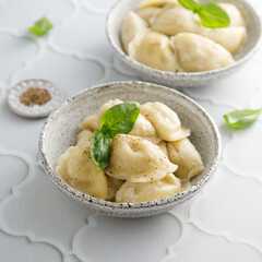 Homemade dumplings served with fresh basil
