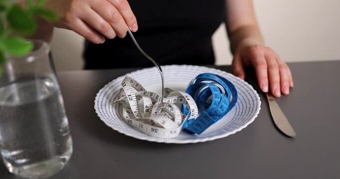 An original visualization of the problem of a person with an eating disorder. objects that symbolize obsession with weight loss