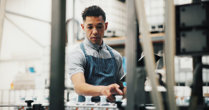 Distillery, inspection and man in factory on tablet for alcohol production, manufacturing and checklist. Brewery, industrial business and person on tech for fermentation, quality control and storage