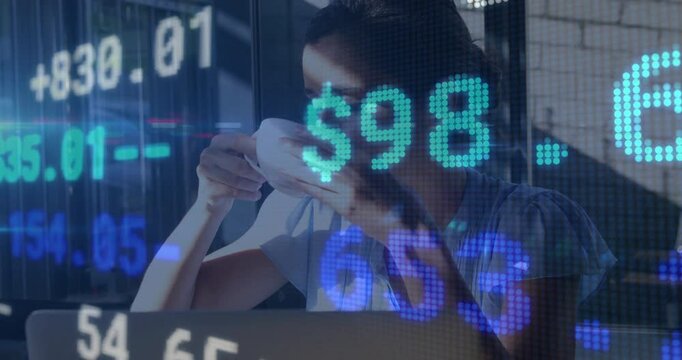 Woman sipping coffee at desk, showing animated stock market data graphs for finance - Powered by Adobe
