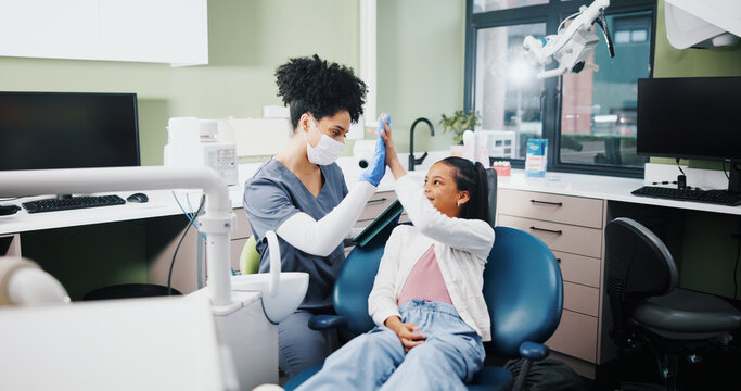 Dentist, girl and high five with smile for results, motivation or support for oral health at hospital. Woman, child and celebration for teeth whitening, happy or tooth extraction with care at clinic