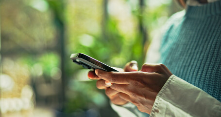 Hands, business and person typing with phone in office for communication, research and sustainable consultant. Advisor, space and mobile app for schedule update, reading information and green project