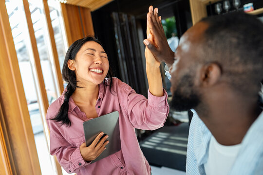 Online entertainment and social media. Diverse, multiethnic couple enjoying the digital world