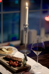 dinner in a restaurant with wine, beautiful table setting, a glass of wine in the foreground