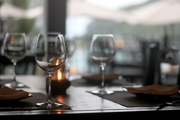 table setting in the restaurant, glasses and cutlery, a clean new table in the restaurant is waiting for guests, a free table