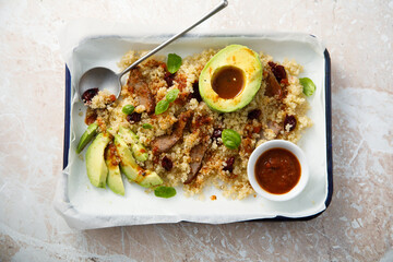 Warm quinoa salad with avocado and meat