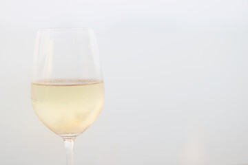 Wine glass close-up in real life, beautiful blurred background of the drink in the glass