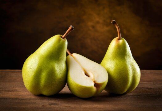 There are three pears sitting at a table