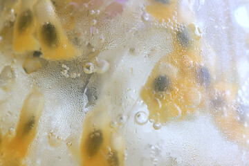 passion fruit lemonade background, cold lemonade in a glass, delicate texture cold tropical drink background