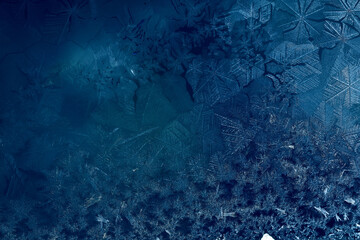 winter blue background ice frozen texture on the window