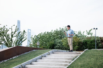 asian businessman using smart phone while having coffee