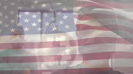 Dentist wearing scrubs under overhead light, patient in dental chair facing x-ray with flag overlay