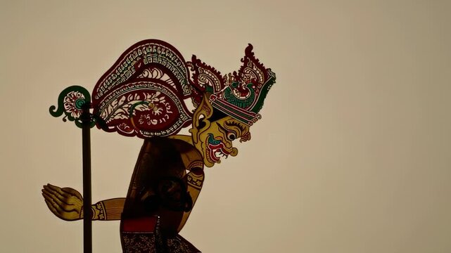 Intricate Brown Shadow Puppet with Red and Green Accents