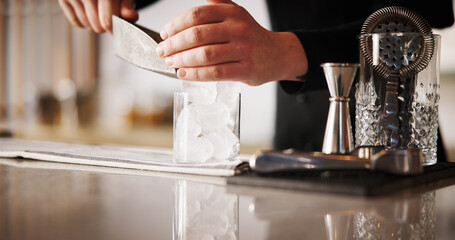 Cocktail, ice and hands of bartender man with glass, cafe and tools for artisan beverage recipe. Mixology, small business pub and barman at counter with happy hour drinks, process and craft alcohol