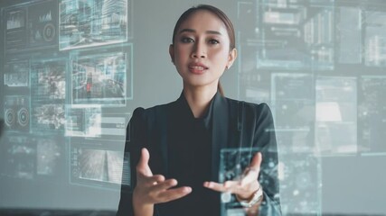 Businesswoman navigating digital interface: A focused businesswoman interacts with a holographic interface, surrounded by numerous digital screens displaying data and information. - Powered by Adobe