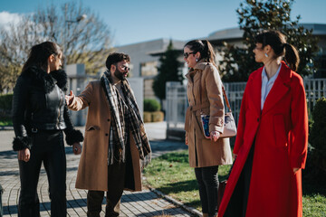 A group of professionally dressed friends engaged in an animated discussion outdoors under clear skies.