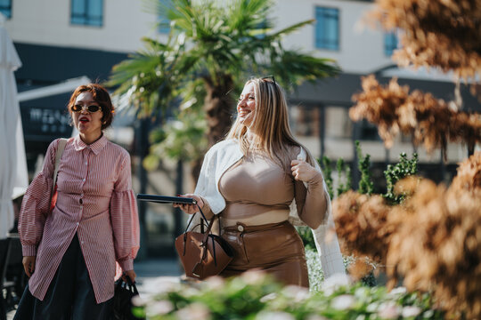 Two confident business colleagues stroll through a vibrant urban area, enjoying a sunny day. They exude professionalism and camaraderie in a multicultural city environment. - Powered by Adobe