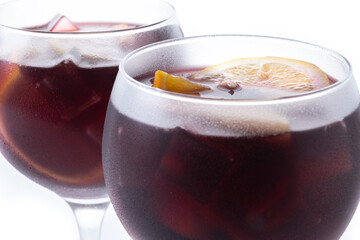 Refreshing Summer Citrus Fruit Sangria in crystal glass isolated on white background. Close up