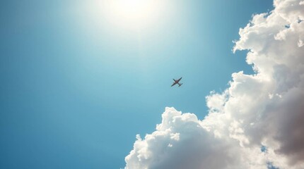 High-flying passenger plane soaring through a clear blue sky with bright sunshine and clouds.