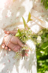 Branch of a blossoming flowers in a woman's hands. Spring blossom