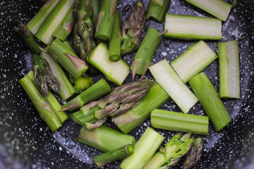 Green asparagus on pan close up. Asparagus spears being cooked in a hot pan. Asparagus close up....