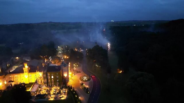 A fireworks show over a castle at night