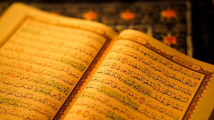Open book with intricate text and gold detailing, reflecting cultural significance and spirituality.