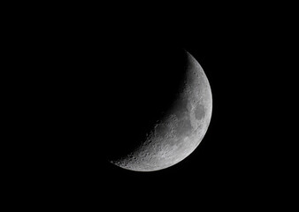 Waxing Crescent moon glowing taken May 2, 2025 above Ottawa, Canada against a black background.