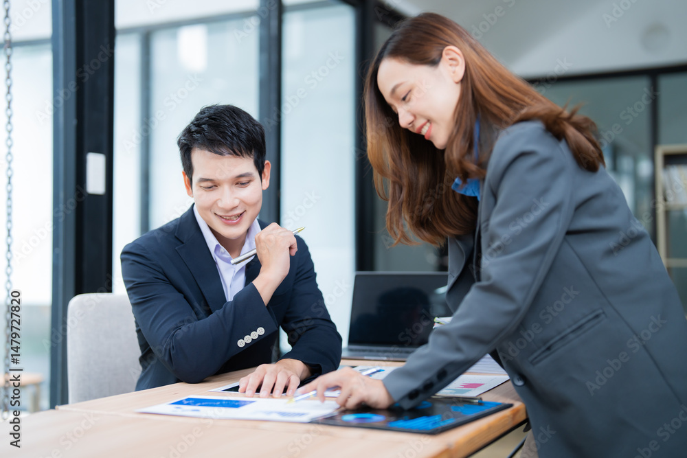 Poster two asian businesspeople are discussing and analyzing financial charts and data using documents and 