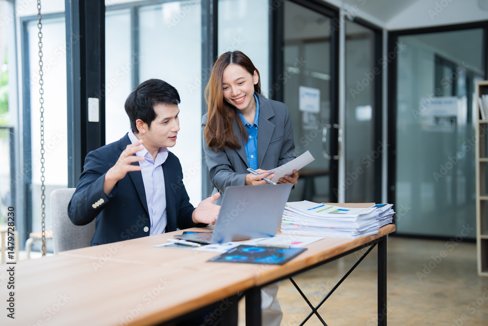 Aufkleber two asian businesspeople are discussing and working together using laptop and documents in a modern 