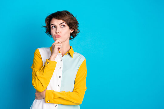 Photo of doubtful unsure lady dressed shirt arm chin looking empty space isolated blue color background
