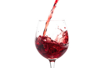 A close up shot of red wine being poured into a clear glass on a black background creating a splash
