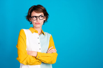 Portrait of grumpy woman nerd in formal shirt folded arms and glasses look empty space bad thoughts...