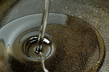 Vegetable oil poured into cast iron pan macro process.