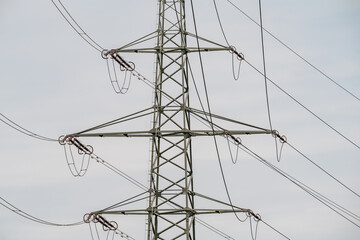 High voltage pylon with overhead power lines. Horizontal photograph.