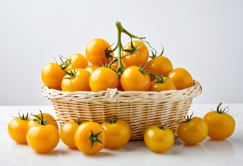 There are lots of yellow tomatoes in one basket on the table