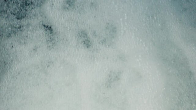 Foam forming a hole on a liquid surface