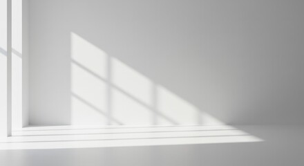 Bright white interior space illuminated by soft, natural light patterns through a window