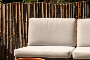 Relaxing outdoor seating with a stylish bamboo backdrop. Perfect for patios and gardens.