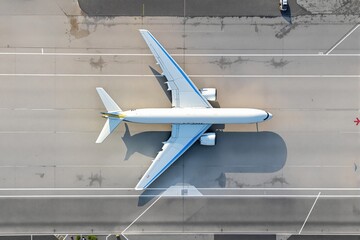 Large airplane viewed from top on airport runway, creative aerial photo, gray concrete background, concept of aviation and travel. Ai generative