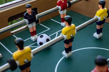 A close-up shot of a foosball table game in action.  Perfect for sports, leisure, and competition...