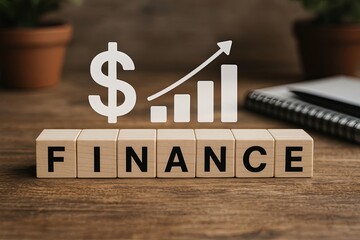 Blocks showing 'FINANCE' with dollar sign and bar chart overlay, natural desk environment