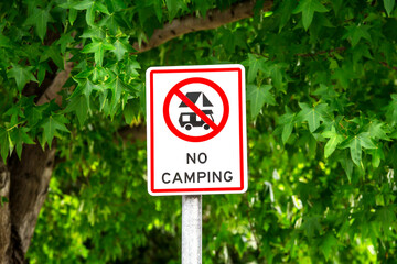 No camping parking sign in public park.