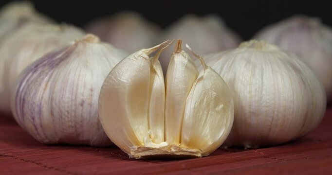 Garlic, Allium sativum, species of bulbous flowering plants in genus Allium. Garlic - very healthy product with many beneficial properties for health. Cinema 4K 60fps zoom-in video