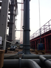 Industrial Construction Site Featuring Pipes and Machinery in Progress
