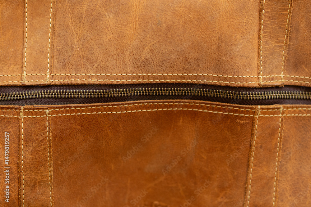 Poster High-resolution image of brown leather texture with a visible zipper. Ideal for backgrounds, textures, and design projects.