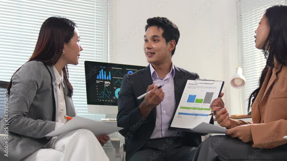 Aufkleber two businesspeople are sitting in a modern office, actively discussing graphs and reports, analyzing