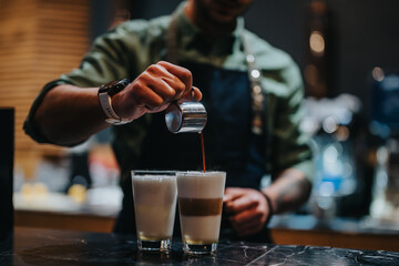 A skilled barista crafting layered coffee drinks with precision in a cozy, modern cafe. The scene captures the artistry of coffee preparation, emphasizing detail, craftsmanship, and the appeal of