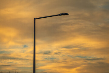 Modern street lamp, lighting pole with a lamp powered by a solar panel against the background of...
