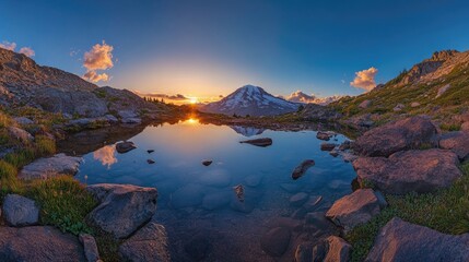 Majestic mountain reflected in tranquil alpine lake at sunrise.